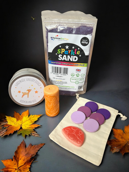 Cub & Bear Ltd sensory play kit with violet sparkle sand, handmade dough, wooden discs, and orange rolling tool.